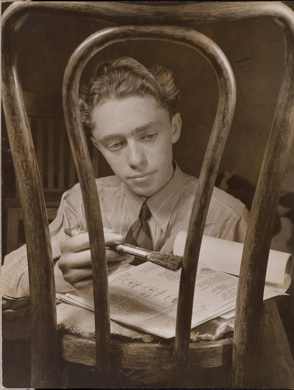 [Jonge man schildert de rugleuning van een houten stoel]. door Arnold Eagle