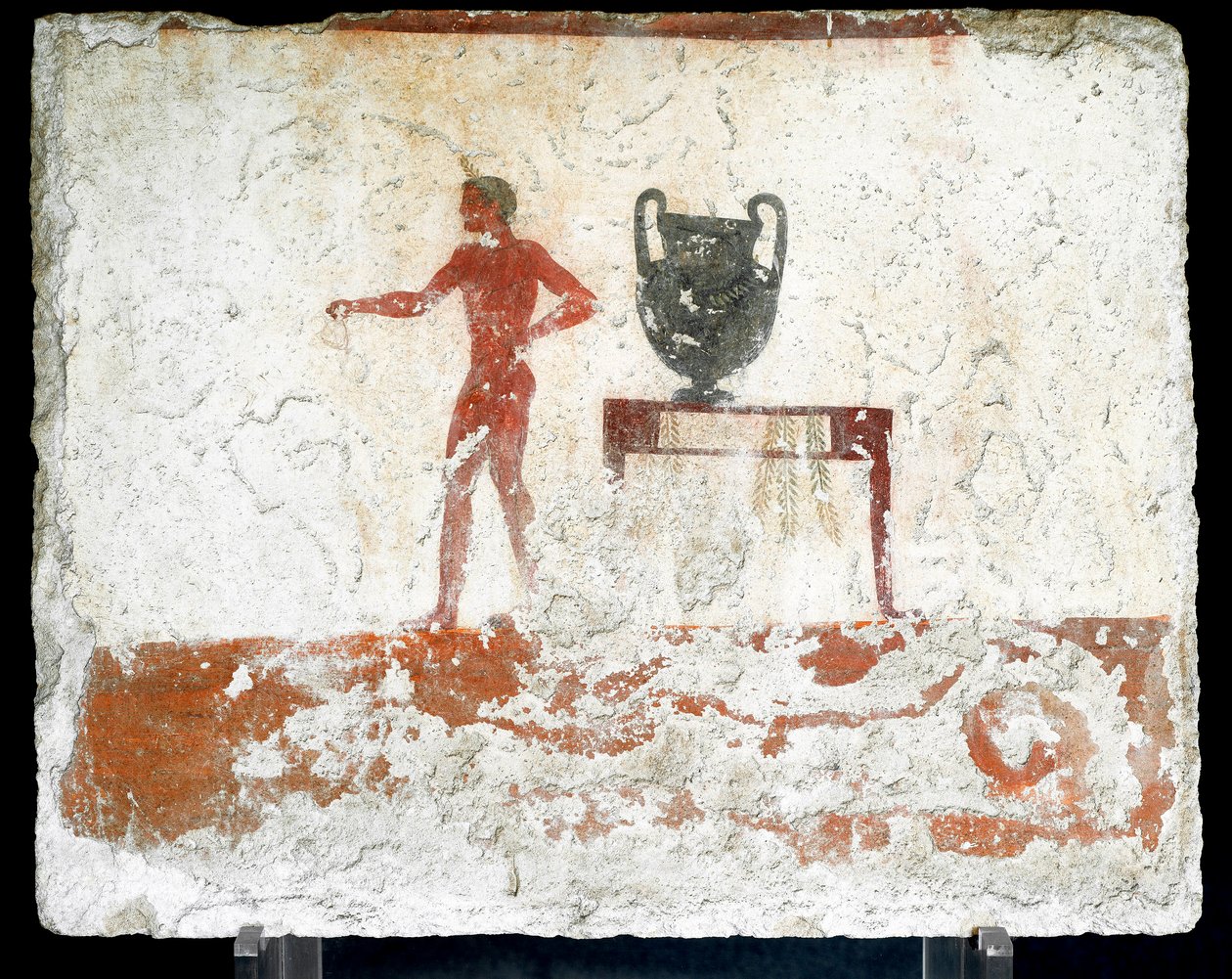 Etruskische kunst: een jonge naakte ephebe bij een tafel waar een vaas op staat. Fresco van het graf van de 