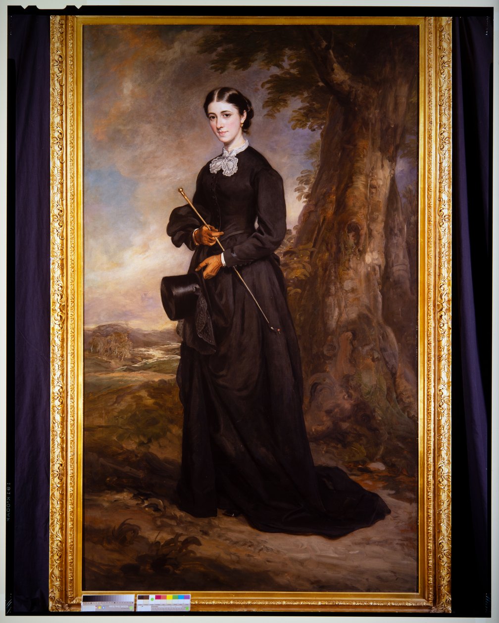 Portret van een dame in een zwart rijgewaad, staand in een landschap door Francis Grant