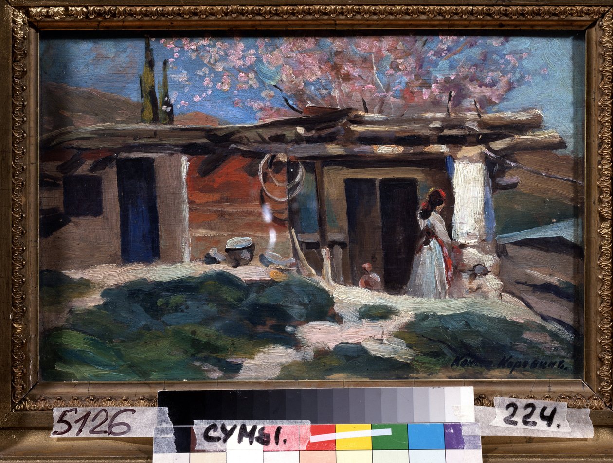 Krim, bloeiende amandelbomen. Jonge vrouw voor een klein houten huis, onder de roze amandelbomen door Konstantin Alekseevich Korovin