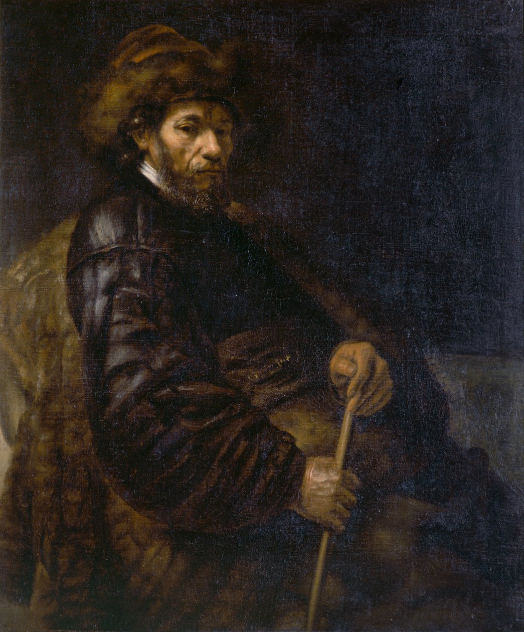 Een zittende man met een stok door Rembrandt Harmensz. van Rijn