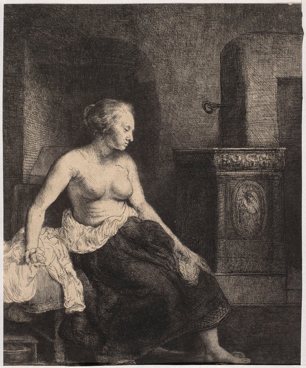 Een halfnaakte vrouw die bij de kachel zit door Rembrandt van Rijn