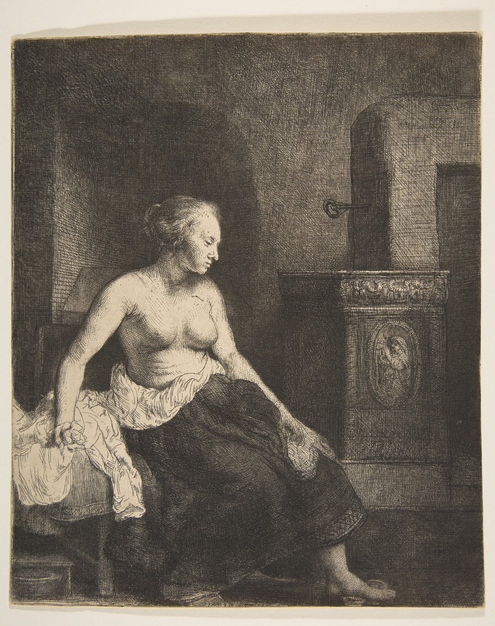 Halfgeklede Vrouw Zittend naast een Kachel door Rembrandt van Rijn