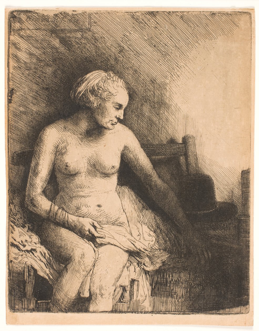 Vrouw in bad, met een hoed naast haar door Rembrandt van Rijn