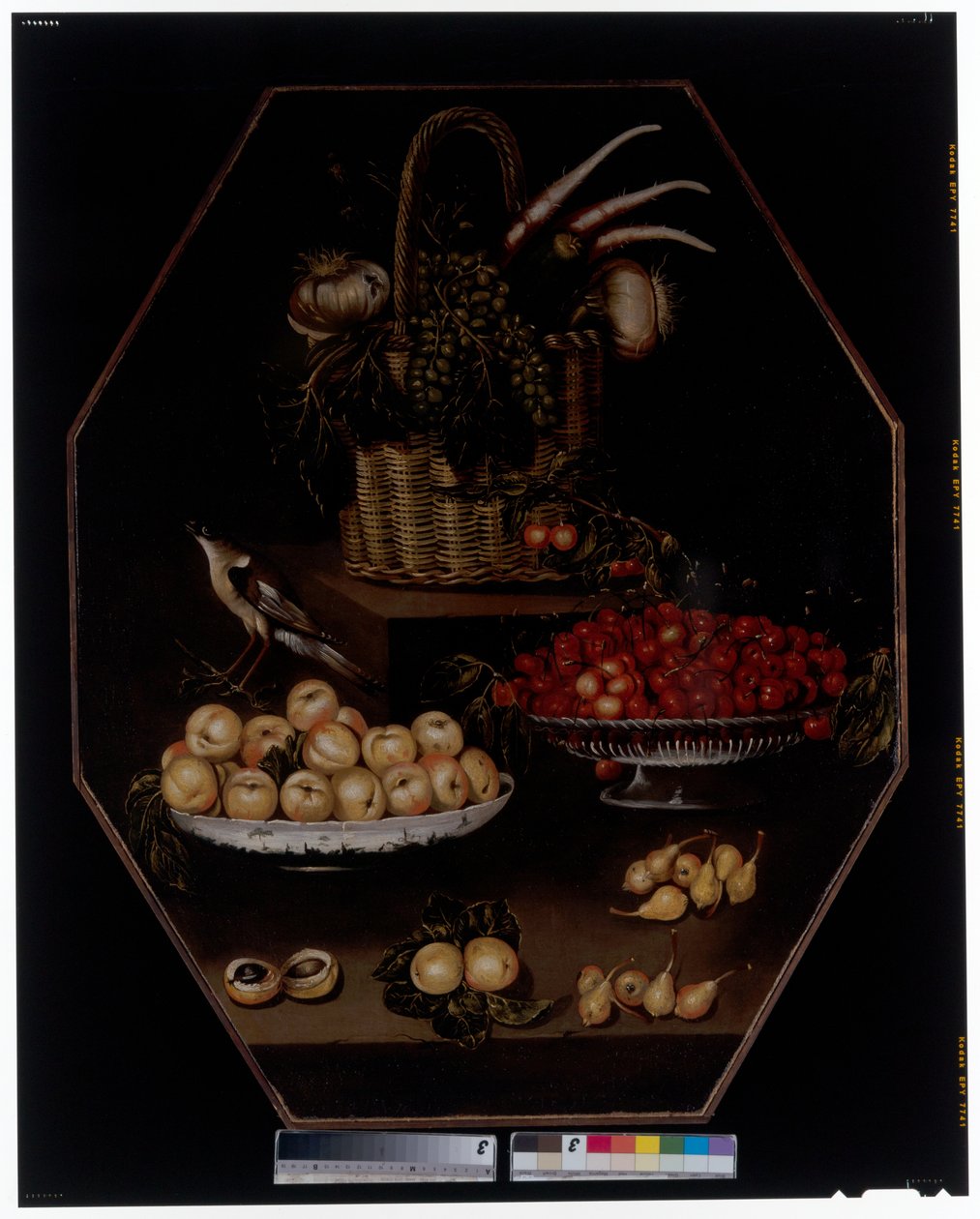 Een stilleven met granaatappels en druiven in een mand door Spanish School