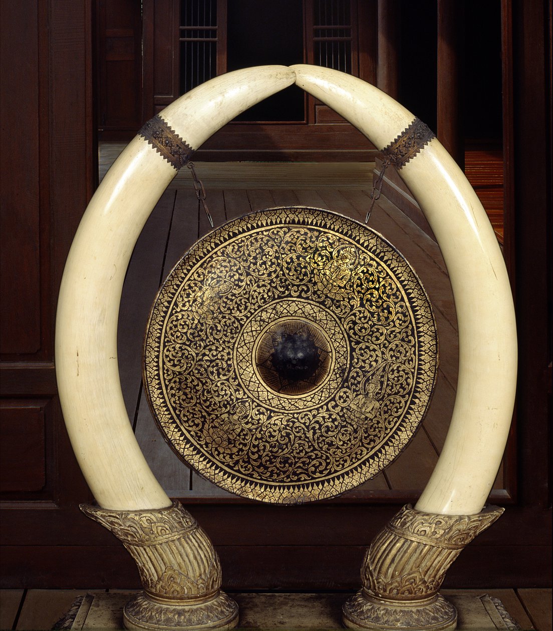 Een gong hangend aan olifantenslagtanden (metaal en ivoor) door Thai School