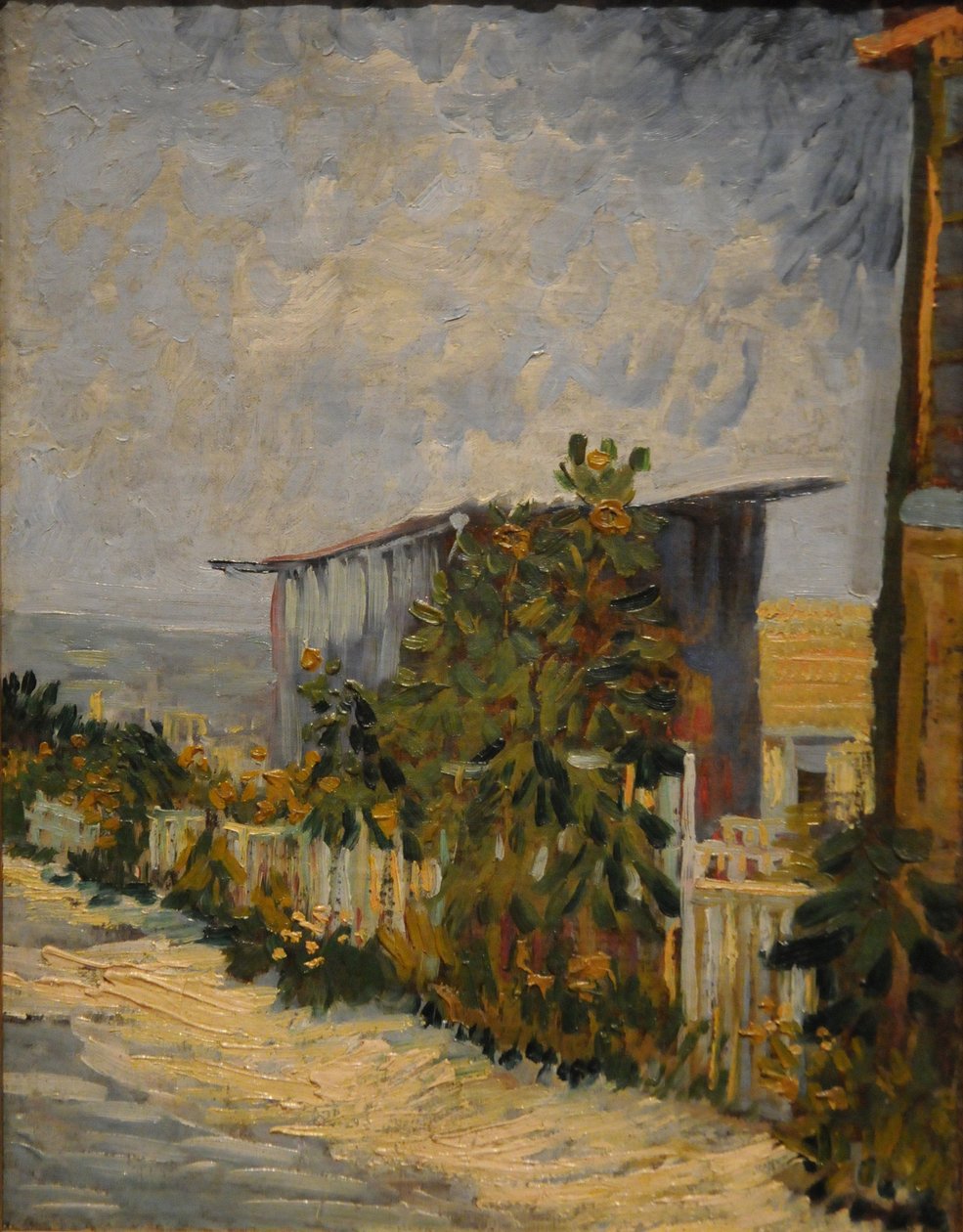 Schuur in Montmartre met zonnebloem, 1887 door Vincent van Gogh