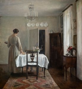 De vrouw van de kunstenaar de tafel dekken door Carl Holsoe