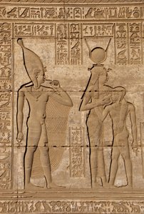 Egyptische oudheid: Romeinse mammisi ter herdenking van de geboorte van Ihy, zoon van Hathor - Detail van reliëfs en hiërogliefen: de godin Isis - Hathor die haar zoon Ihi (Ihy) voedt en achter haar een ander beeld van Ihi met een vinger in zijn mond door Egyptian Ptolemaic Period