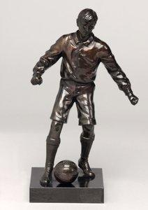 Voetballer, onderdeel van een klokset
