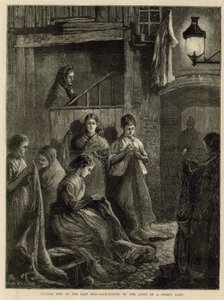 Londens leven in het Oostelijke Einde - zakken maken bij het licht van een straatlantaarn door English School
