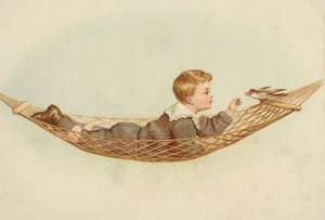 Jongen liggend in een hangmat die een vogel voedt door European School