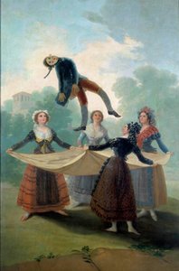 Jonge vrouwen gooien een lappenpop in de lucht met een doek