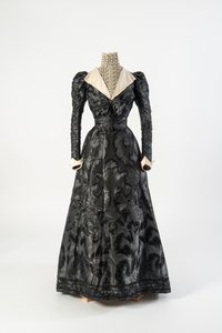Zwart zijden jurk met hoge hals chemisette van crèmekleurig kant, vroege jaren 1890