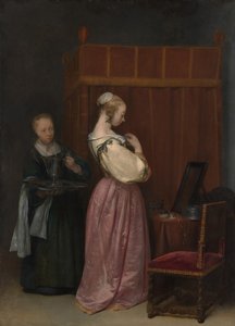 Een jonge vrouw bij haar toilet met een dienstmeid