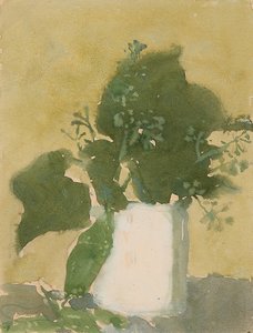 Groene bladeren in een witte kan