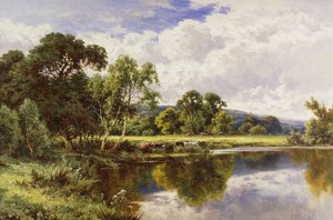 Een bebost rivierlandschap met vee