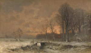 Winters tafereel met de zon die achter de bomen ondergaat