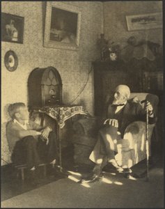 [Man en jongen zitten in een studeerkamer].