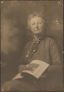 [Woman Holding Magazine].