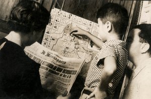 Een vrouw leest de voorpagina van The Messenger met de titel "De driekleur wappert zegevierend van Adwa heroverd".