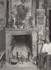 [Man bij een open haard]. door Marion Post Wolcott