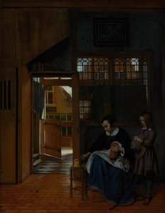 Een vrouw bereidt brood en boter voor een jongen