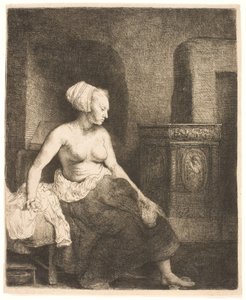 Vrouw zittend half gekleed naast een kachel door Rembrandt van Rijn