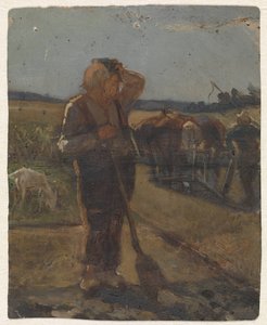 Boer staand met schep op het land