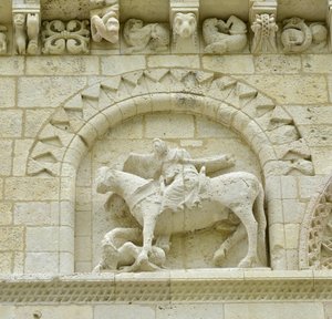 Romaans kunst: detail van de gevel die Hugues de Surgeres en Geoffroy de Vendome of keizer Constantijn de Grote afbeeldt, wiens paard de ketterij vertrapt en Christus triomfeert over het kwaad en de dood, Notre Dame de Surgeres door Unbekannt