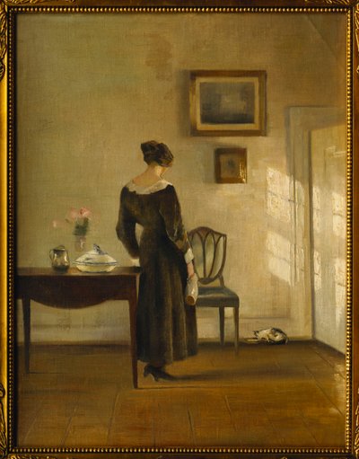 Een Interieur met een Vrouw die een Kat Voedt door Carl Holsoe