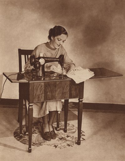 Huisvrouw aan het werk op de naaimachine, midden jaren 1930 (zwart-wit foto) door English Photographer