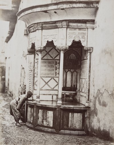 Een man drinkt uit een hoekfontein, op een straat in Damascus, Syrië door Félix Bonfils