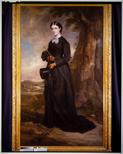 Portret van een dame in een zwart rijgewaad, staand in een landschap door Francis Grant