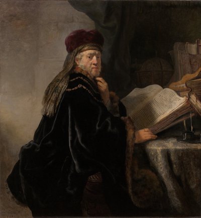 Een geleerde zittend aan een bureau door Rembrandt van Rijn