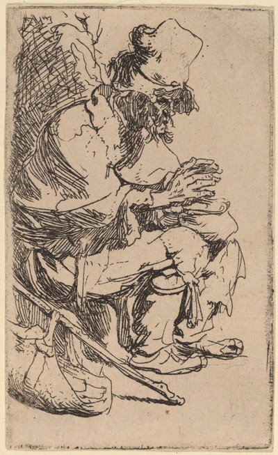 Bedelaar zittend zijn handen warmend aan een stoof door Rembrandt van Rijn
