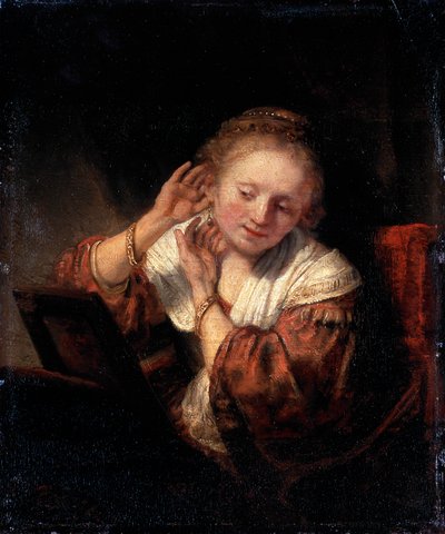 Jonge vrouw die oorbellen probeert, 1657 door Rembrandt van Rijn