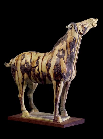 Chinese kunst: terracotta grafbeeldje met driekleurige glazuren van een hennend paard. Uit het graf van prinses Yong Tai (502-594 n.Chr.), Chensi. Tang-dynastie (618-907 n.Chr.) door Tang Dynasty Chinese School