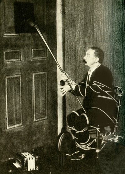 John Nevil Maskelyne voert een spirit cabinet illusie uit, ca. 1910 door Unbekannt