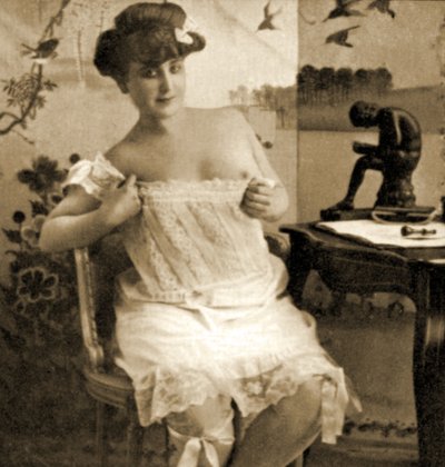 Jonge vrouw toont een kanten hemd, ca. 1900 door Unknown