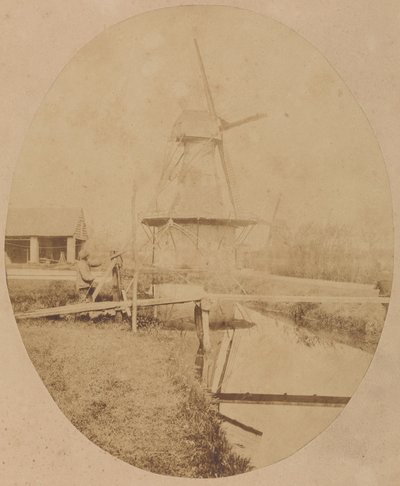 [Schilder met hoed op schildersezel die een windmolen schildert]. door Unknown artist