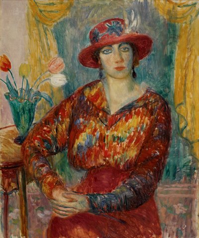 Vrouw in rode blouse met tulpen door William James Glackens