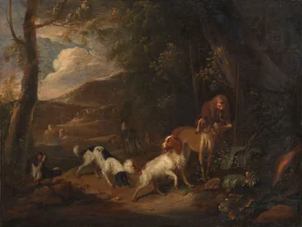 Jager met honden aan de rand van een bos