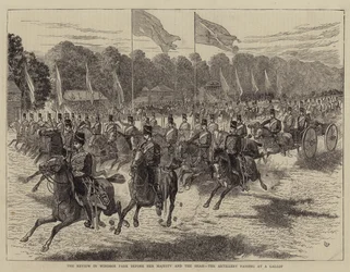 De parade in Windsor Park voor Hare Majesteit en de sjah, de artillerie passeert in galop