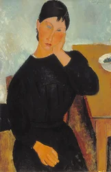 Elvira rustend aan een tafel