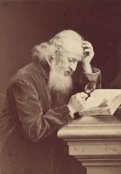 [Bearded Man with Magnifying Glass Examining a Manuscript], 1870s