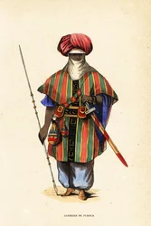 Adellijke Toeareg krijger van Agadez, Niger, in tagelmust (tulband en sluier), taktkat (hemd) en akarbey (broek)