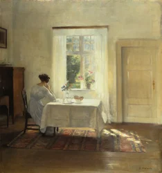 Een vrouw zittend aan een tafel bij een raam, ca. 1900