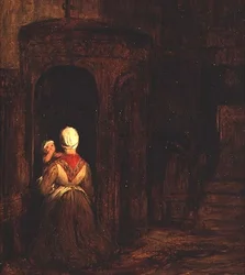Vrouw met een baby knielend bij een biechtstoel