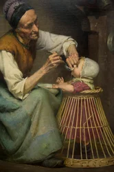 Een oude vrouw voedt haar kleindochter in een rieten babywalker